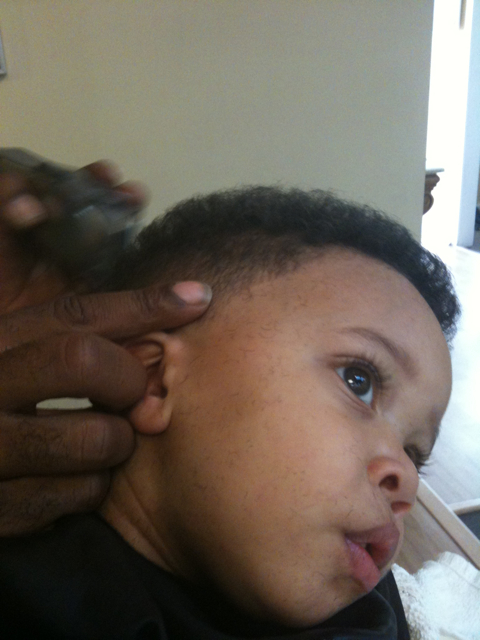 Monica's youngest son Romelo in the barber's chair