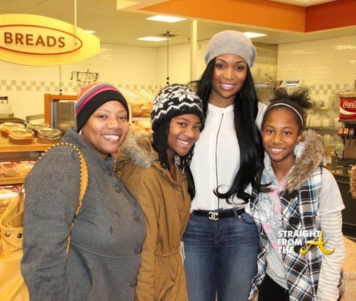 Marlo with a family at her Simply Giving Thanksgiving meal giveaway.